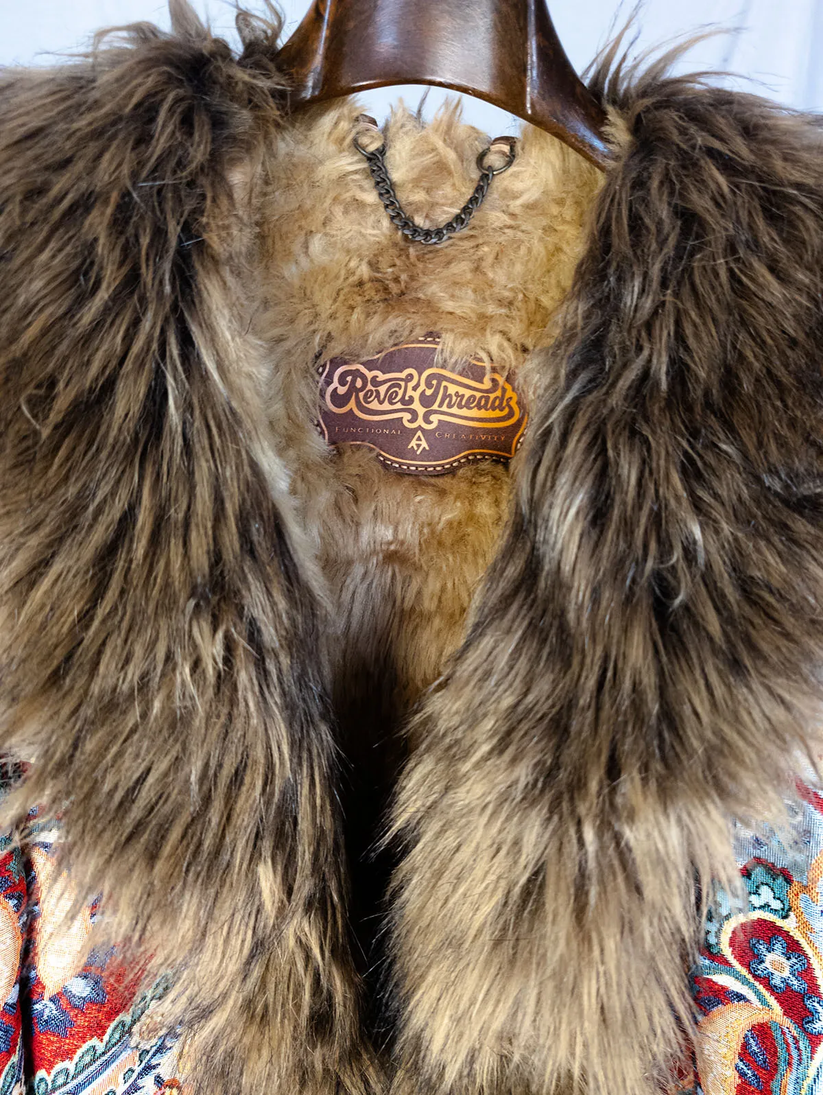 Fela Ultimate Festival Coat close up of logo patch and collar – premium festival coat by Revel Threads