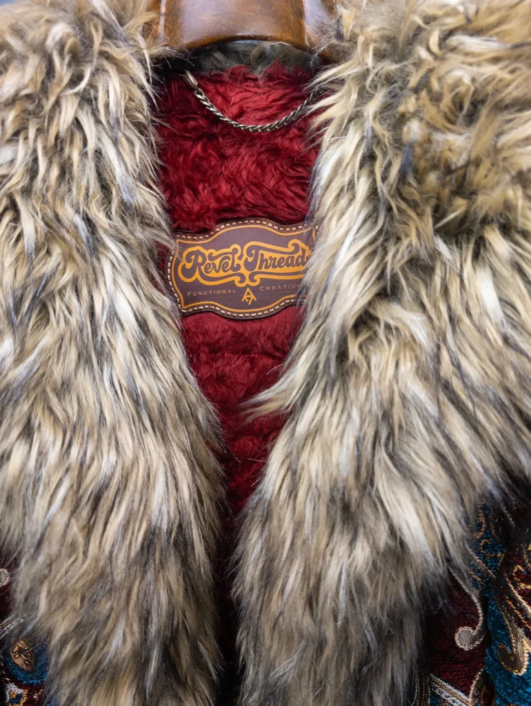 Huxley Luxe Festival Coat close up of logo patch and collar – premium festival coat by Revel Threads