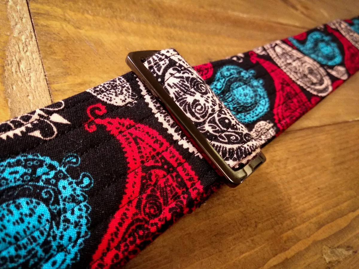 Three P Sweet guitar strap leather ends close-up, vivid high-contrast orange, Blue, Beige and Red Paisley on Black Background colours, real leather ends - Sexy Straps by Revel Threads